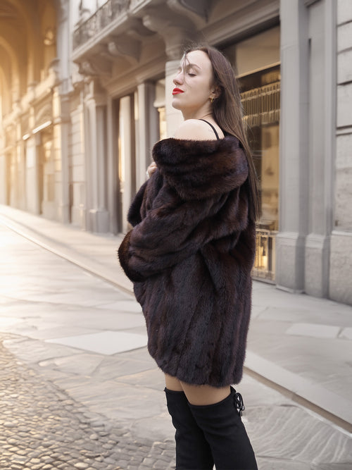Golden hour street style with rich brown mink coat, styled for elegant cold-weather fashion with modern flair.
