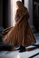 Brown full-length mink fur coat with flared hem and thick collar, side profile