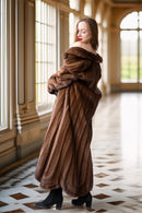 Brown mink fur coat with rounded collar and oversized draped sleeves, back view