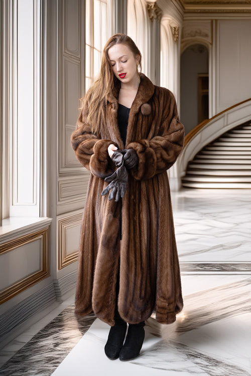 Brown mink fur full-length coat with buttoned front, wide collar, and textured cuffs