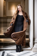 Brown mink fur coat with open front, wide shawl collar, and long draped sleeves