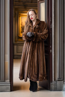 Brown full-length mink fur coat with structured collar and rounded sleeve cuffs
