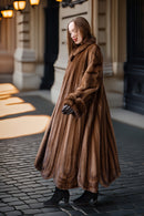 Brown mink fur coat with large collar, long sleeves, and flared full skirt