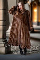 Brown mink fur coat with sculpted vertical panels and voluminous skirt
