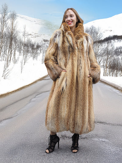 Model in red fox coat on winter road