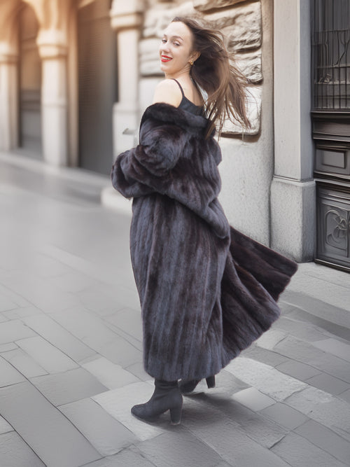 Woman spinning in Midnight Sonata black mink coat, showcasing the coat’s luxurious fullness and elegant winter appeal.