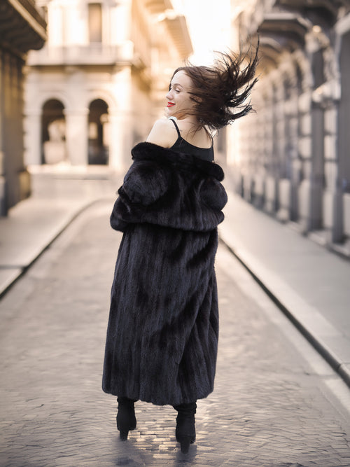 Model flipping hair in Midnight Sonata black mink coat, capturing the drama and elegance of real fur fashion.