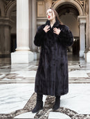 Midnight Sonata black mink coat styled in a neoclassical hall, emphasizing timeless elegance and premium fur craftsmanship.
