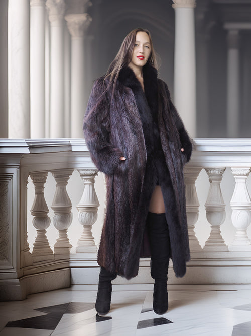 Woman wearing a long dark fur coat in an elegant interior setting