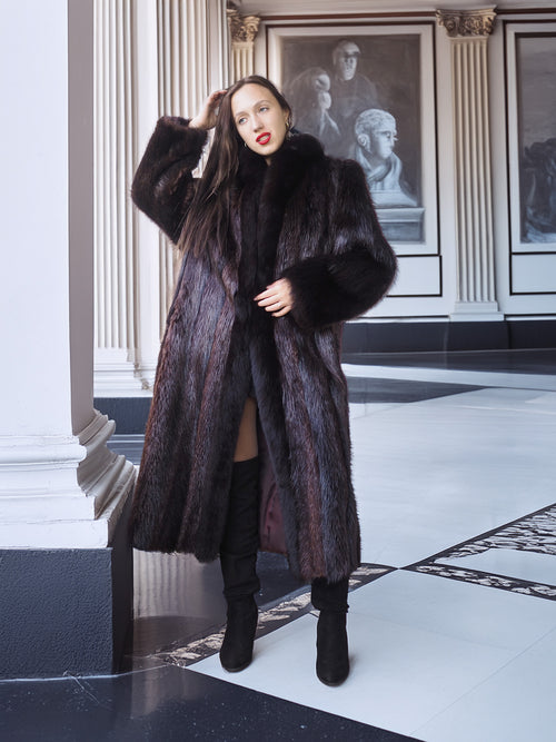 Woman wearing a fur coat in an elegant interior setting