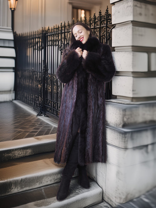 Woman in a fur coat standing on steps with a decorative metal railing in the background