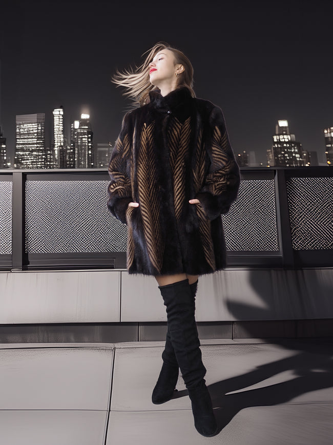 Woman in a patterned coat and knee-high boots standing on a rooftop with a city skyline in the background.
