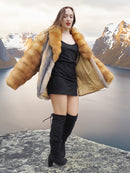 The Wild Muse fox fur coat in red and gray tones, opened to reveal golden lining, styled on a cliff with dramatic fjord views.