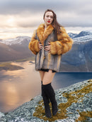 Red and gray fox fur coat by The Wild Muse, styled with thigh-high boots in a Nordic mountain setting for a bold winter fashion statement.