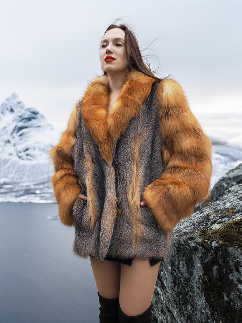 Cinematic red gray fox fur coat from The Wild Muse, modeled on a snowy cliff, emphasizing its luxury fur wear appeal and winter sophistication.