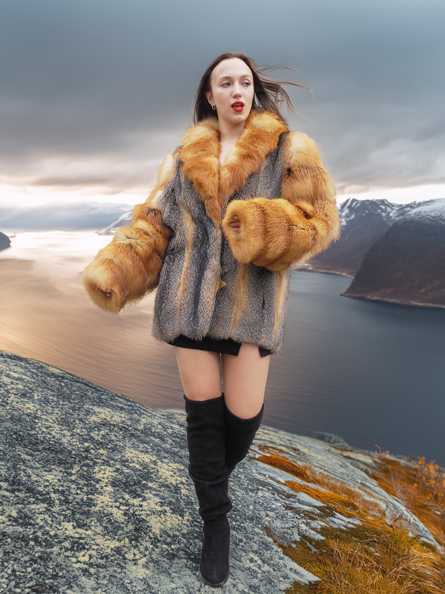 The Wild Muse fox fur coat with dramatic sleeves and collar, styled in a stormy mountain scene for a high-fashion outerwear look.