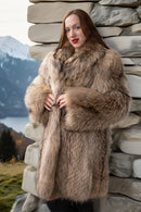 Honey raccoon fur coat, hoodless neckline with thick cuffs; close-up on soft texture