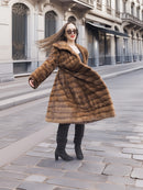 Graceful twirl in Harlow pastel mink coat with shawl collar, showcasing the coat’s volume and rich brown mink fur.