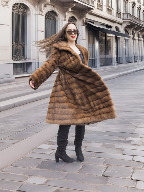 Graceful twirl in Harlow pastel mink coat with shawl collar, showcasing the coat’s volume and rich brown mink fur.
