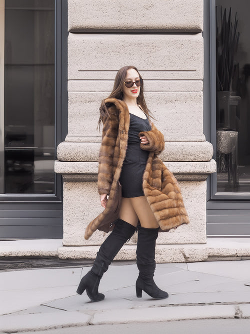 Harlow pastel mink coat with shawl collar styled with black dress and boots, perfect for a chic winter streetwear look.