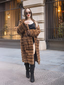 Model adjusts Harlow pastel mink shawl collar coat, highlighting the coat’s plush texture and elegant vintage design.