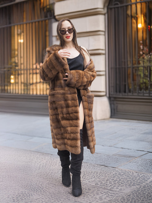 Model adjusts Harlow pastel mink shawl collar coat, highlighting the coat’s plush texture and elegant vintage design.