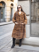 Relaxed pose in Harlow pastel mink coat with shawl collar, styled with black boots for a timeless outerwear look.