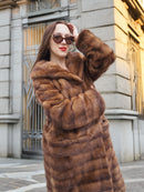 Golden hour lighting on Harlow pastel mink coat with shawl collar, emphasizing the rich brown tones and soft fur texture.