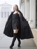 Model opens red and black mink fur coat to reveal black mini dress, blending vintage fur with modern fashion.