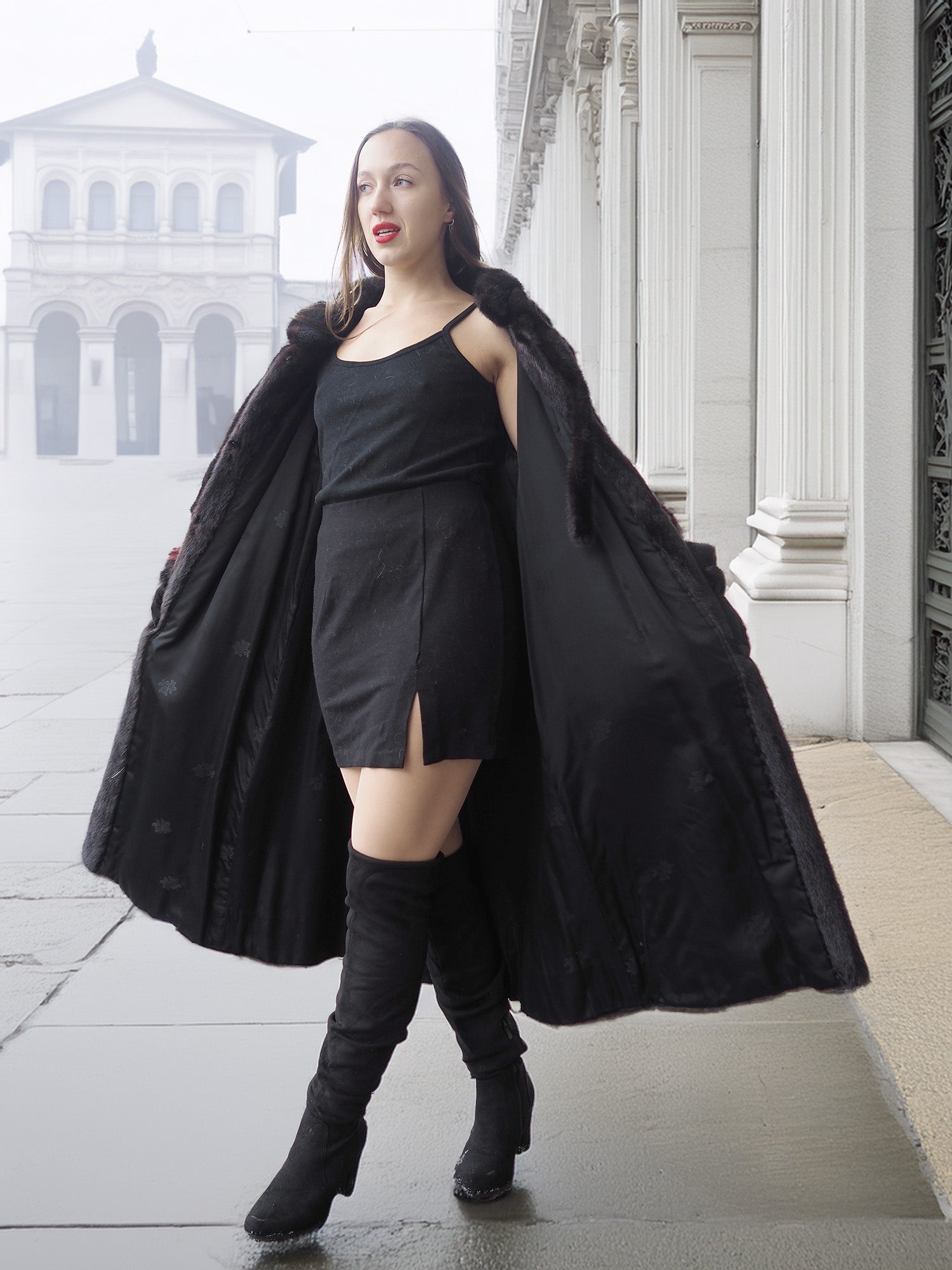 Model opens red and black mink fur coat to reveal black mini dress, blending vintage fur with modern fashion.