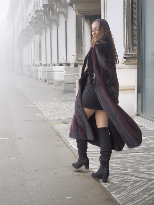 Side view of open red and black mink fur coat revealing black outfit underneath, perfect for chic winter layering.