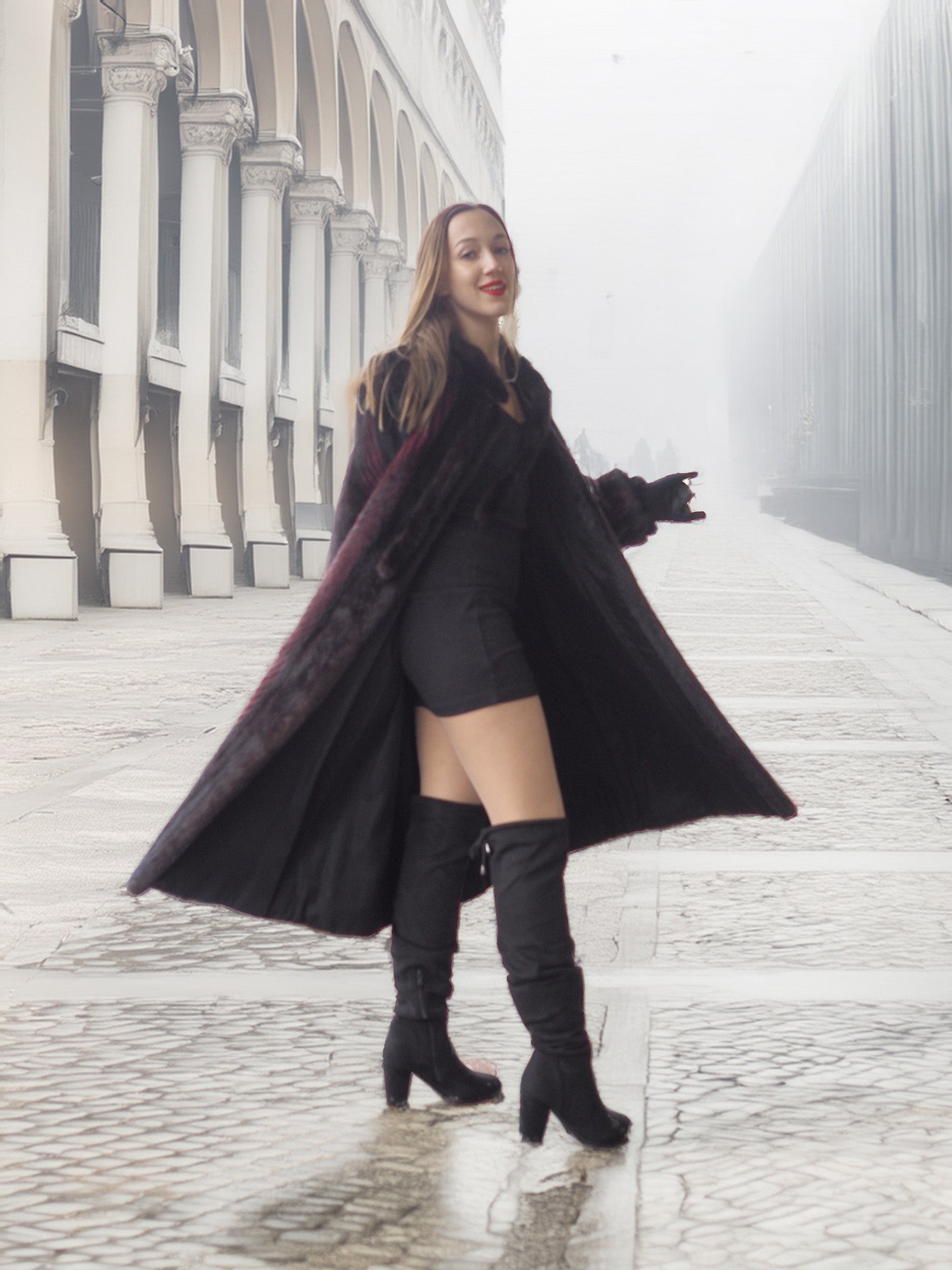 Model twirls in open red and black mink fur coat, revealing black mini dress for bold winter fashion statement.