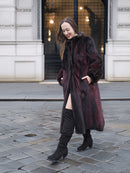Model walks on wet cobblestone in red and black mink fur coat, ideal for stylish and warm winter outerwear.