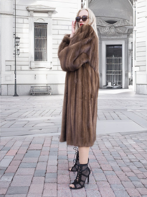 Luxurious pastel-hued Canadian brown mink fur coat with silk lining, worn by a fashionable woman on a city street.