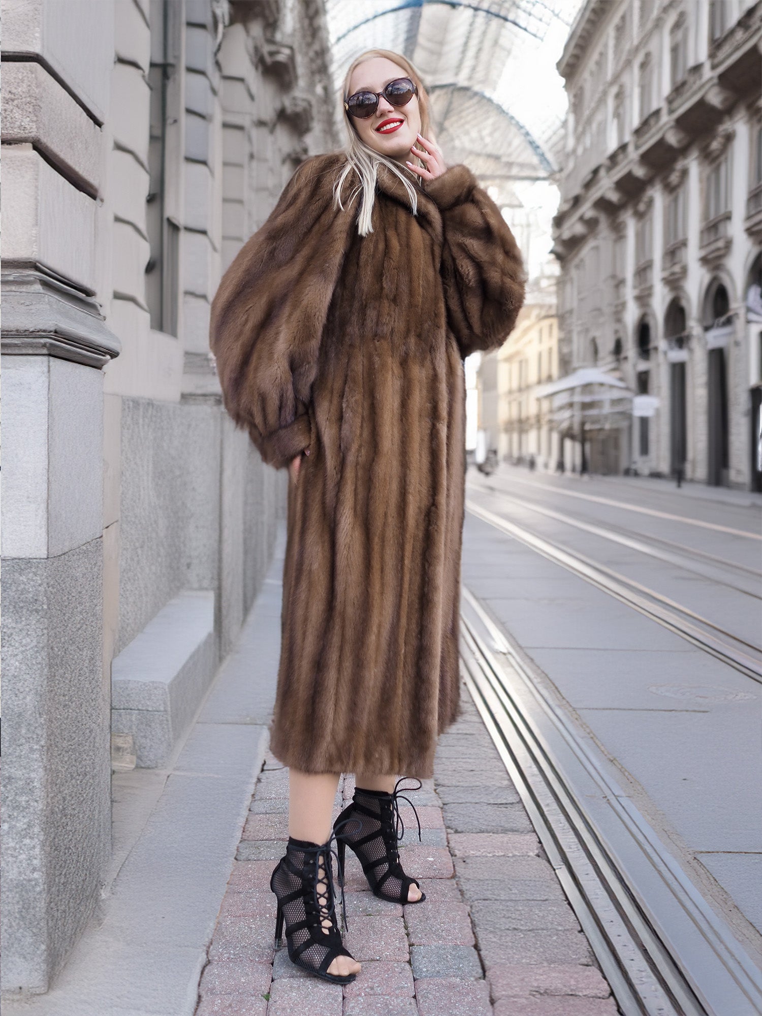 Elegant woman in luxurious vintage Canadian brown mink fur coat with silk lining, walking on city street.
