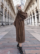Luxurious vintage Canadian brown mink fur coat with silk lining, showcased in a grand indoor shopping gallery.