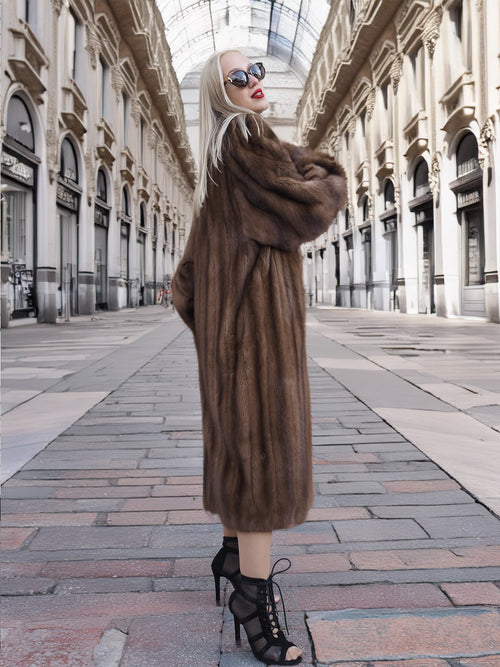 Luxurious vintage Canadian brown mink fur coat with silk lining, showcased in a grand indoor shopping gallery.