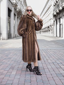 Luxurious pastel brown mink fur coat with silk lining, worn by fashionable woman on city street.