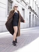 Elegant vintage Canadian brown mink fur coat with silk lining, worn by a stylishly dressed woman on a city street.