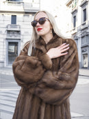 Elegant vintage Canadian brown mink fur coat with silk lining, showcased on city street backdrop.