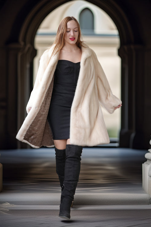 Pearl mink swing coat with hood, cream fur drape over dark mini dress and boots