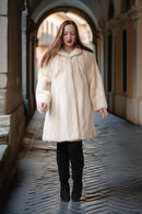 Cream mink coat with swing silhouette, plush collar, and long sleeves