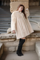 Cream mink coat, side view with plush collar and voluminous swing shape