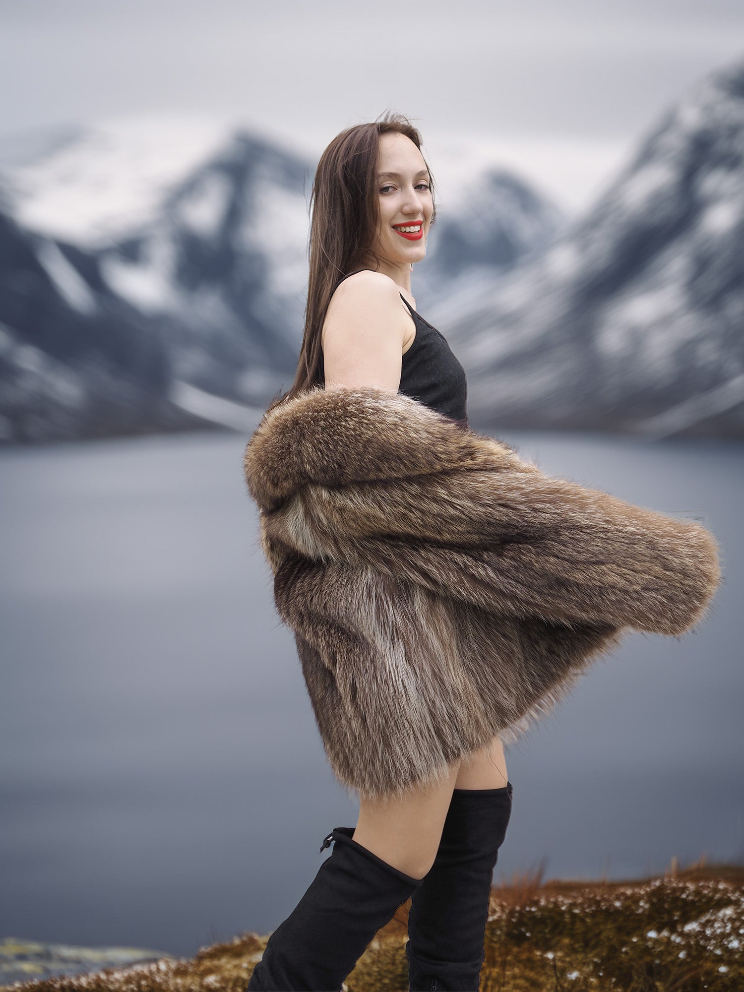 Raccoon Glamour Jacket - Mountain Mirage S/M styled with black dress, highlighting fur movement and alpine elegance.