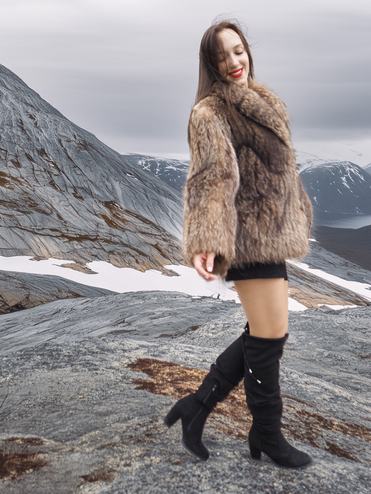 Model twirling in Raccoon Glamour Jacket - Mountain Mirage S/M on icy plateau, capturing playful elegance of fur fashion.