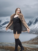 Model draping Raccoon Glamour Jacket - Mountain Mirage S/M over shoulders, revealing satin interior and chic winter layering.