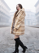 Smiling model in blond pastel mink fur coat stroller jacket, ideal for showcasing sustainable fur and elegant winter style.