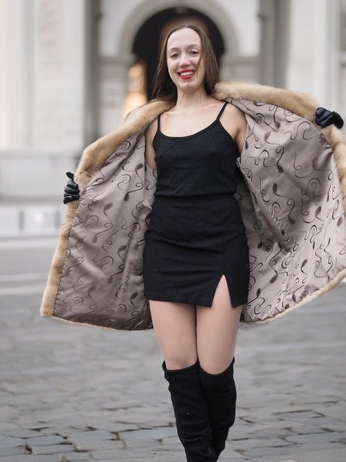 Open view of blond pastel mink fur coat stroller jacket revealing patterned lining, showcasing craftsmanship and stylish design.