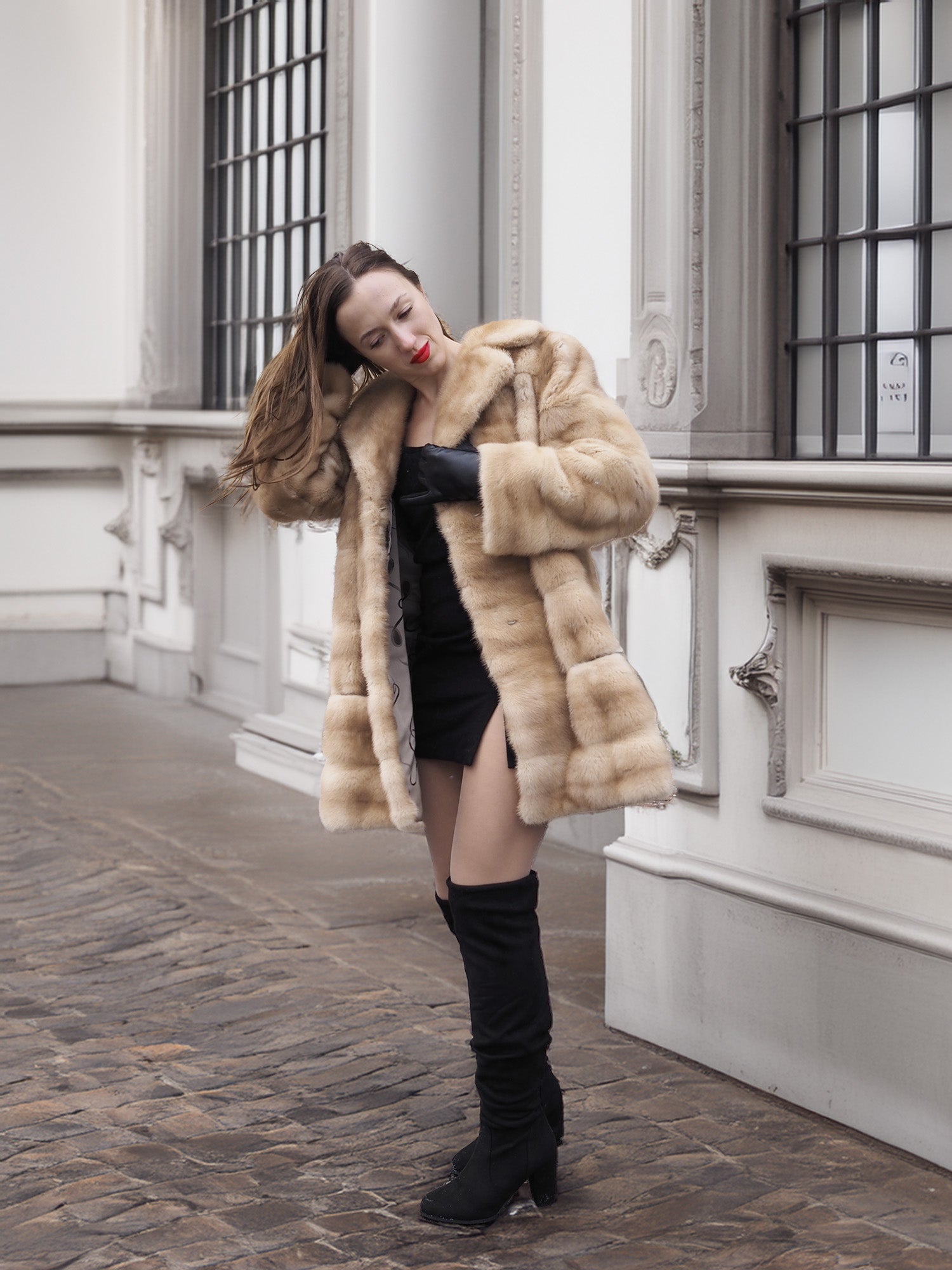 Blond pastel mink fur coat stroller jacket styled with mini dress, highlighting its versatility for upscale winter fashion.