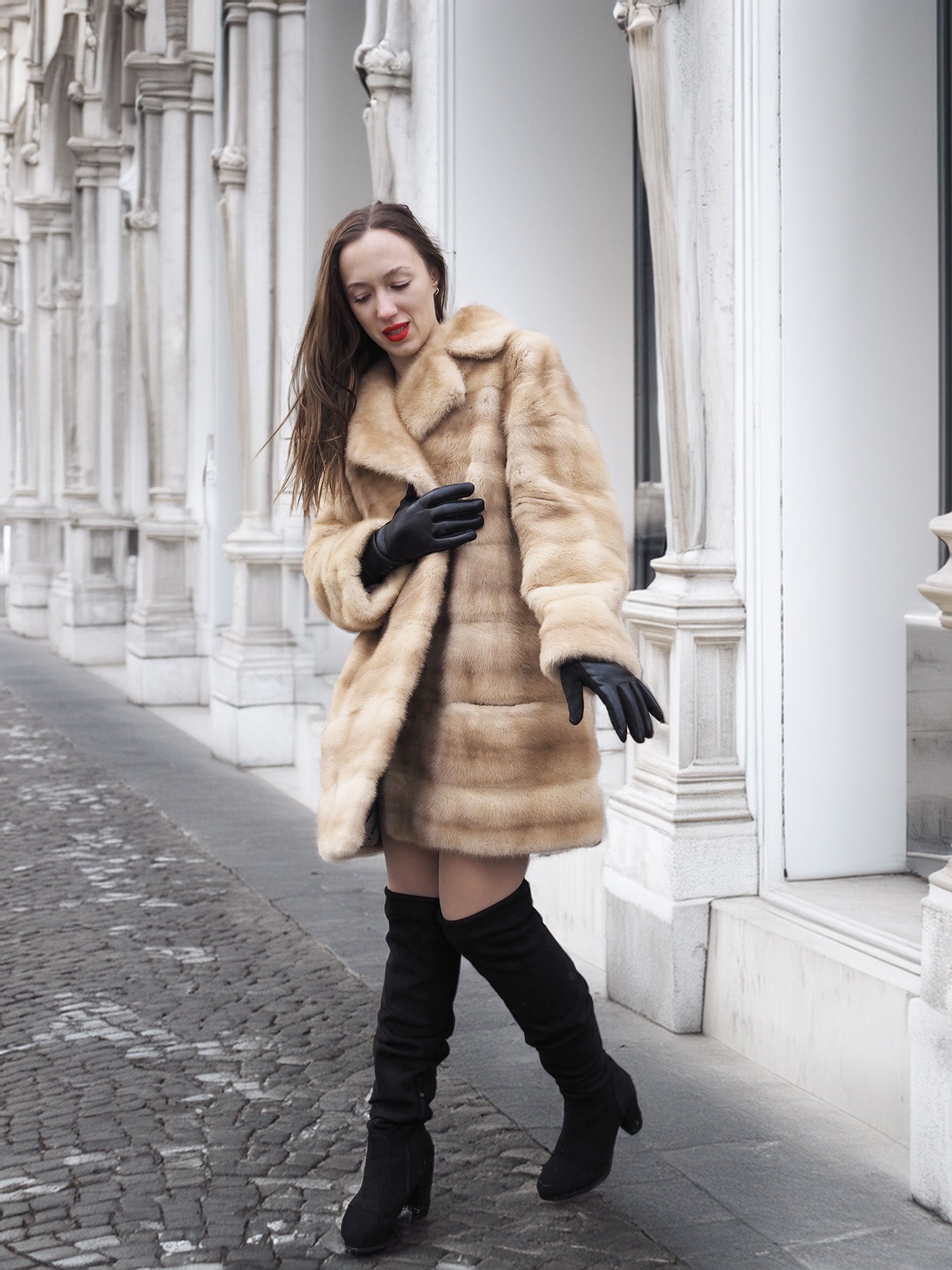 Walking pose in blond pastel mink fur coat stroller jacket, ideal for luxury fur outerwear and elegant street style.